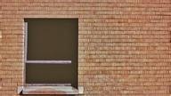 Window on red brick building.