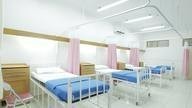 Hospital ward with empty beds.