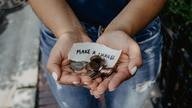 Hands out stretched with coins in palms and 'make a change' note.