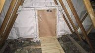 Wooden door next to wooden beams.