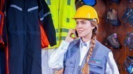 Lady in hard hat on phone.