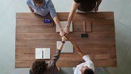 overhead view of people in meeting fist bumping